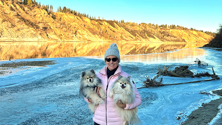 Samantha Taylor, a Provincial Educator/Coordinator for Critical Care, enjoys a sunny walk along the North Saskatchewan River near Fort Edmonton with her twin Pomeranians Harley and Max.