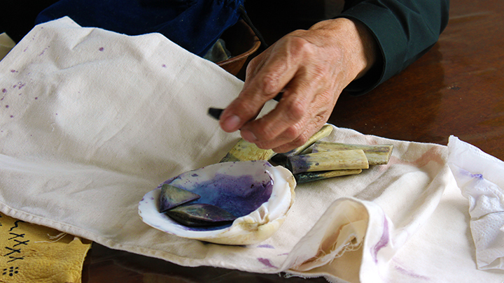 William Singer’s focus is to live by traditional ways in all things. As an artist, he sometimes employs ancient techniques, as shown here. His palette is a clamshell. His brushes are a cut bovine rib bone. His paint is made with berries and flowers.