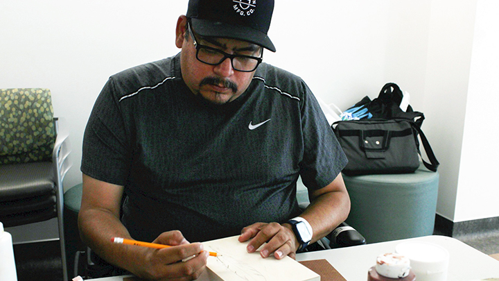 Steven Healy works on a smudge box on his final day of treatment at Chinook Regional Hospital, as part of the Spirit of Art and Reconciliation (SOAR) program.