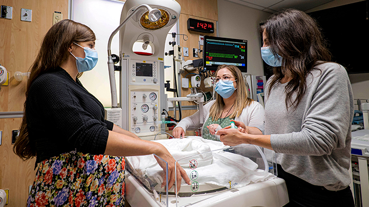 Simulation consultants Nicholle Oomen, left, Megan Rolleman and Cydnee Bryksa work in the Stollery Critical Care Simulation Lab, which opened in May 2021.