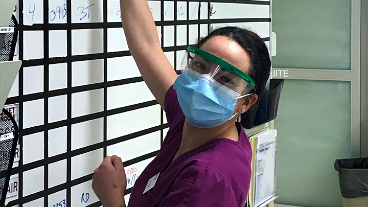 Registered Nurse Amanda Mifsud updates the ER triage board at Myron Thompson Health Centre in Sundre. “I love rural nursing. It's a challenge, but it's one that I welcome. You know, I have been able to use all of my skills that I've learned over the years, and I'm learning more every single day,” she says.