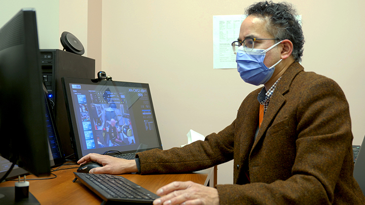 Dr. Tom Jeerakathil uses videoconferencing to interact with his team on the Stroke Ambulance.