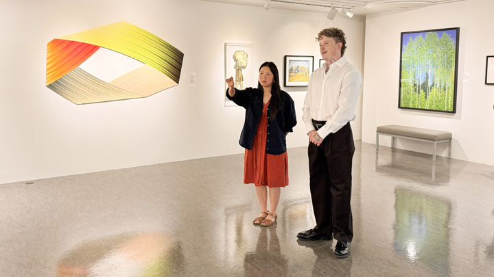Tyler Sherard, right, and Pam Kriangkum admire artwork in the McMullen Gallery at the University of Alberta Hospital.