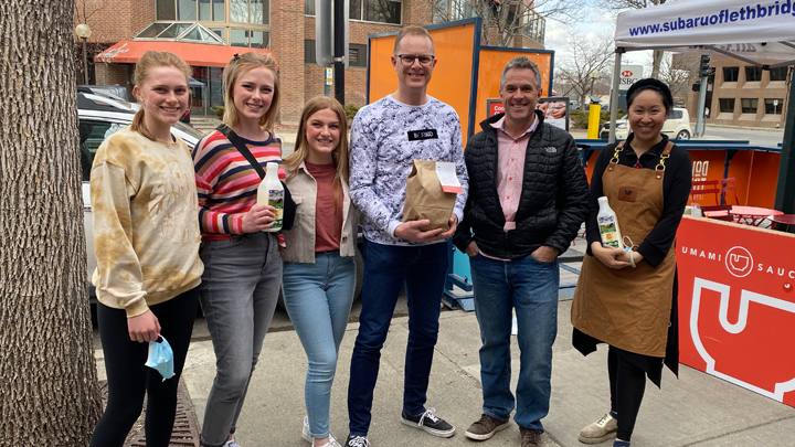 Members of the Zieber family, from left, Johanna, Laurel, Annika and Colin, collect kits from sponsor Ryan Kasko and Umami Shop co-owner Patricia Luu.