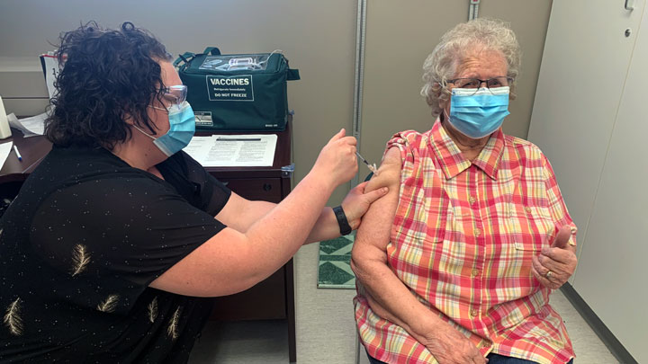 Lavina Barber, 86, gives a big thumbs up as she receives her COVID-19 vaccine shot on her birthday in Camrose.