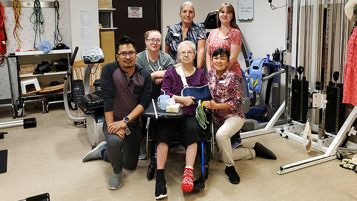 Surrounding new Long Term Care resident Val Lewis are members of her care team, from left: Diones Tizon, Nichole Lang, Diane Mills, Tiffany Schoenthal and Leah Sistoso.