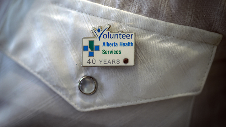 Reg’s 40-year Alberta Health Services volunteer pin says it all — and he’s still going strong.