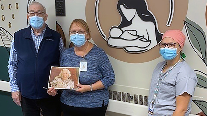 Allen Ford, left, a friend of the Riome family, joins Dr. Beverly Brilz and Dr. Cheyanne Vetter in recognizing the late Molly Riome (shown in photo held by Dr. Brilz). A donation made by Molly and her late husband Bill has funded esthetic upgrades and new equipment for the Obstetrics unit of the Wainwright Health Centre.